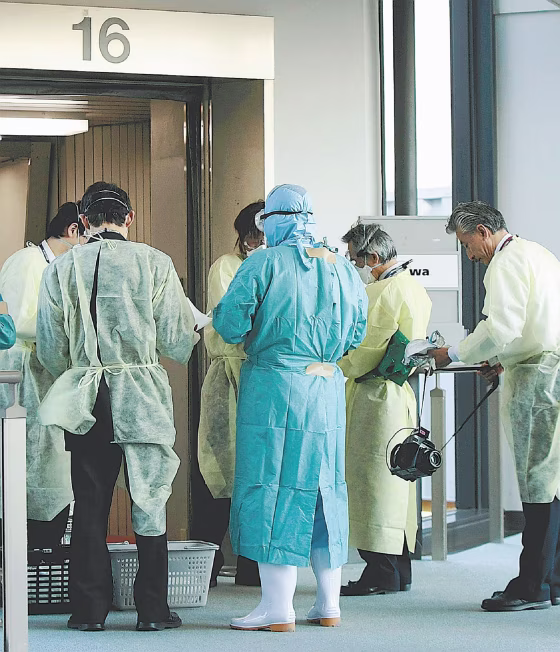Quarantine officers prepare to conduct an on-board inspection of a plane that arrived at Narita Airport from Mexico on Wednesday morning, April 29, 2009.